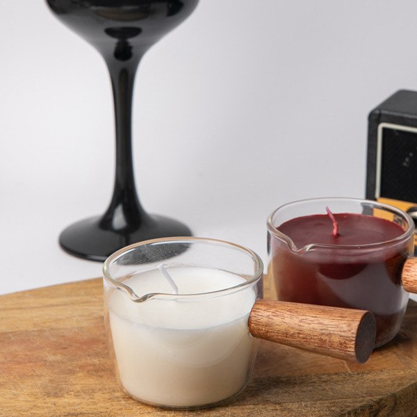 Ember massage oil candles in glass pots with wooden handles